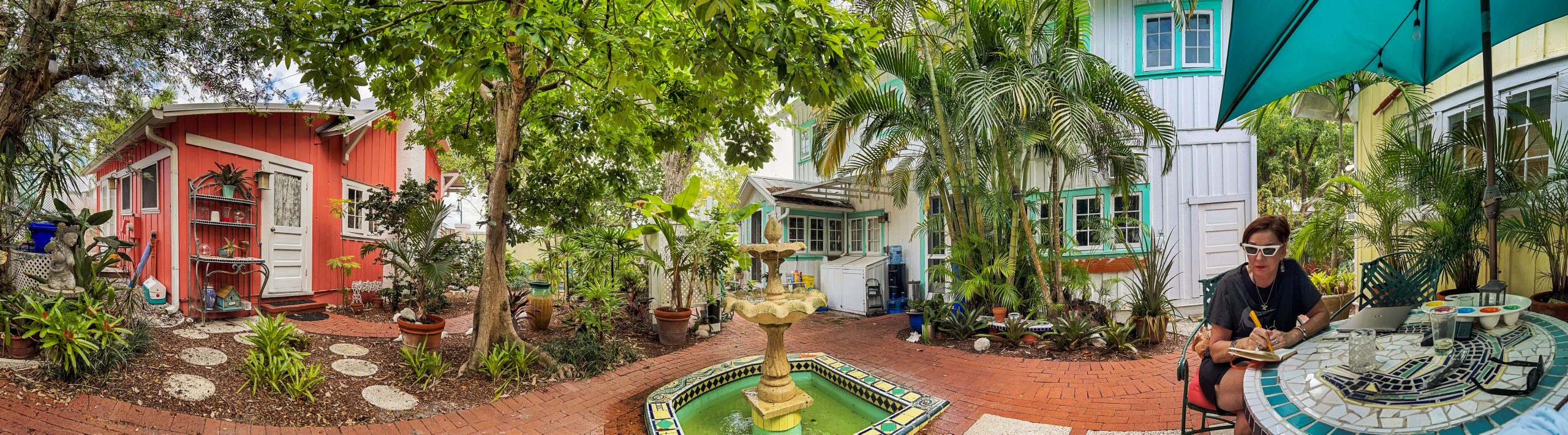 Panoramic view of the Arsenault cottages and tropical courtyard in Naples